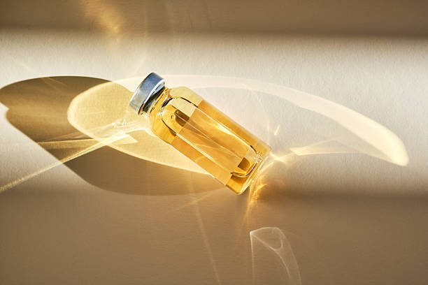 istock Injection vial with medicinal product in sunlight on beige background. 2217749052