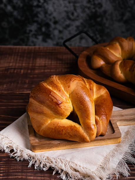 istock Golden Croissant on Rustic Wooden Board 2217749158