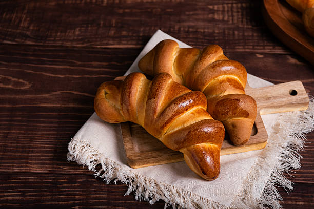istock Golden-Brown Croissants on Rustic Wooden Board 2217749160