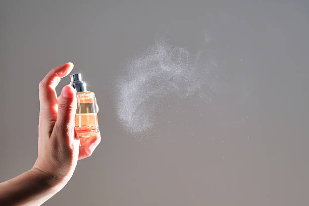 istock The hand sprays perfume from a transparent rounded bottle. 2217750666