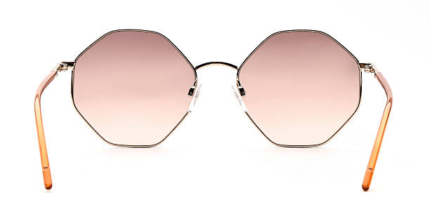 istock Sunglasses back view isolated on white background. Eyeglasses round frame with coral colored uv lens against sunlight on vacation. Glasses circle shape rear view vintage and retro style for design template and poster for sale or marketing. Fashion eyewear 2217750703