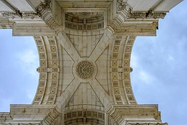 Lisbon, Portugal – February 14, 2024: Intricate ceiling architecture of Rua Augusta Arch in Lisbon against a cloudy sky