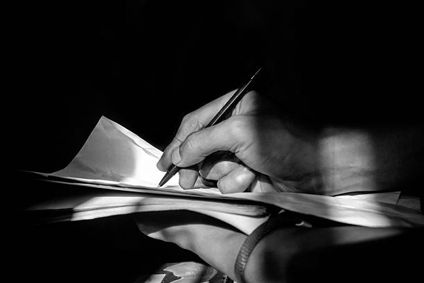 istock Writing in Dark Room Illuminated by Window Light 2217756315