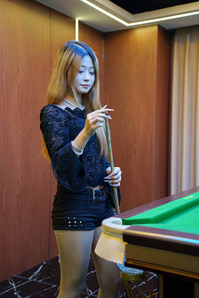 istock Asian woman preparing to play billiards 2217758341