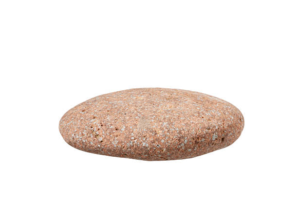 istock red round water stone with sand rock textured surface isolated on white 2217758725