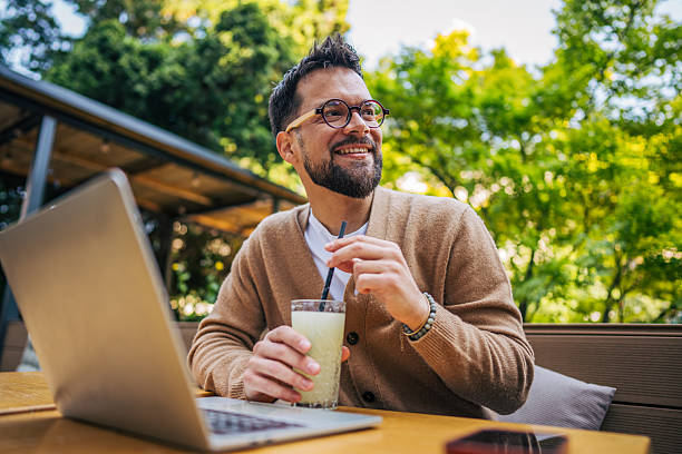 istock Freelancer enjoying a refreshing drink while working outdoors 2217758861