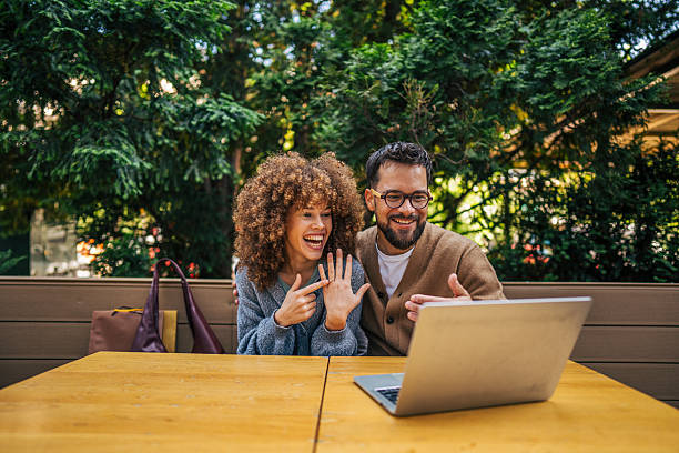 istock Happy couple showing engagement ring on video call 2217758906