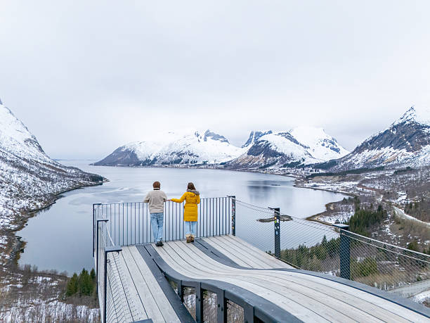 istock Couple Enjoying Scenic Winter View from Mountain Platform 2217759197