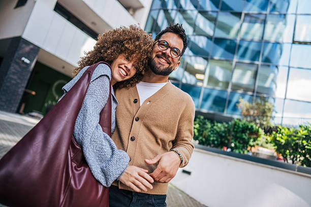istock Happy young couple embracing in urban setting 2217760057