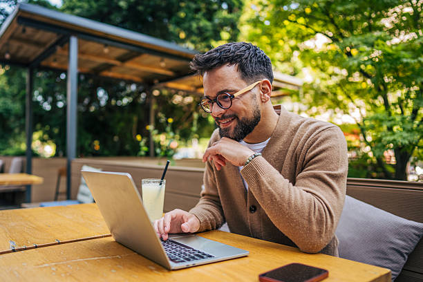 istock Freelancer working on laptop in outdoor cafe 2217760083
