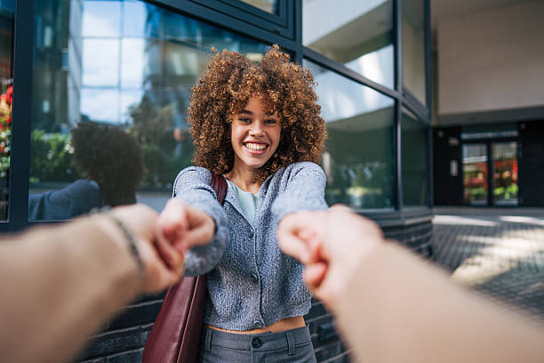 istock Young woman pulling boyfriend's hands walking in the city 2217760149