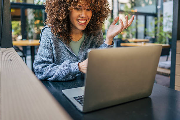 istock Young woman having a video call in a cafe 2217760909