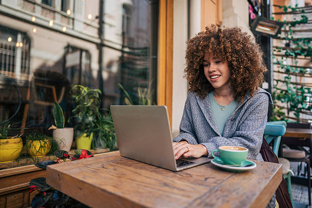 istock Young freelancer working on laptop at outdoor cafe 2217760932