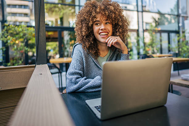 istock Young freelancer woman working on laptop in a modern cafe 2217760962