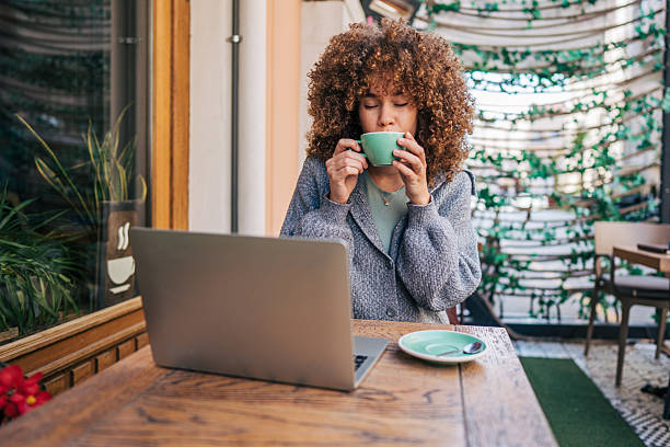 istock Young freelancer woman drinking coffee and working on laptop in cafe 2217761017