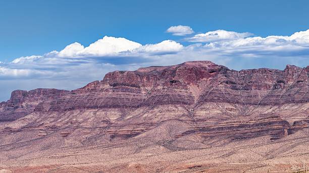 istock View of a desert mountain range under a clear blue sky with scattered clouds in Arizona. 2217761235