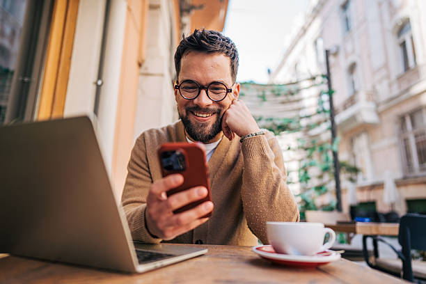 istock Freelancer working remotely from cafe using laptop and smartphone 2217761437