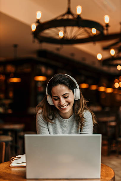 istock Young woman working remotely from a cafe, enjoying her job 2217763584
