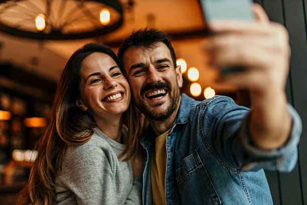 istock Happy couple taking a selfie in a restaurant 2217763897