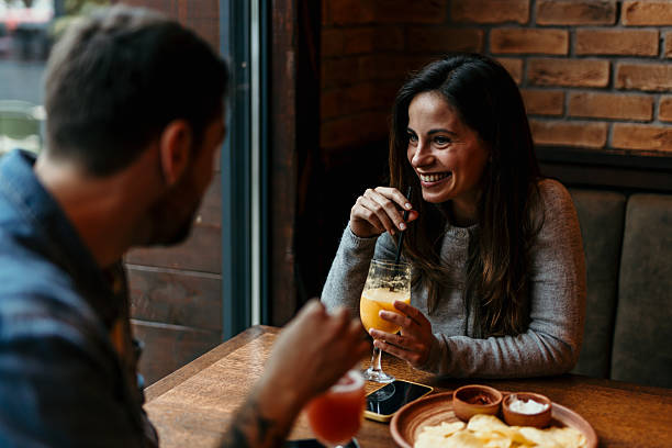 istock Happy couple enjoying drinks and conversation in a restaurant 2217763928