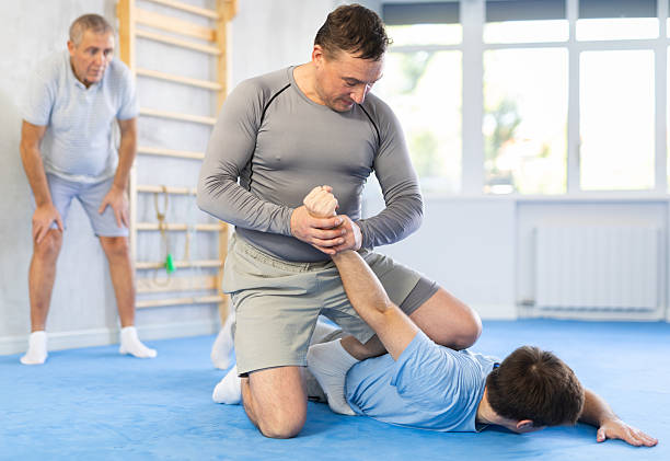 istock Man practicing painful armlock on male opponent at self defence training 2217764371