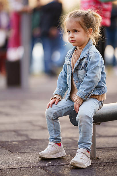istock Girl sitting alone at the playground 2217764609