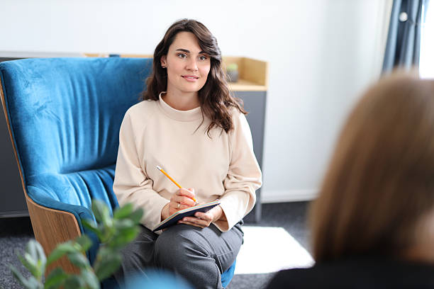 istock Young caucasian female therapist with notepad in counseling session 2217769269