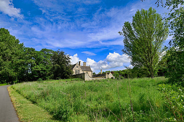 Tourists in the ancient traditional Cotswolds village of Bourton-on-the-Water in summer