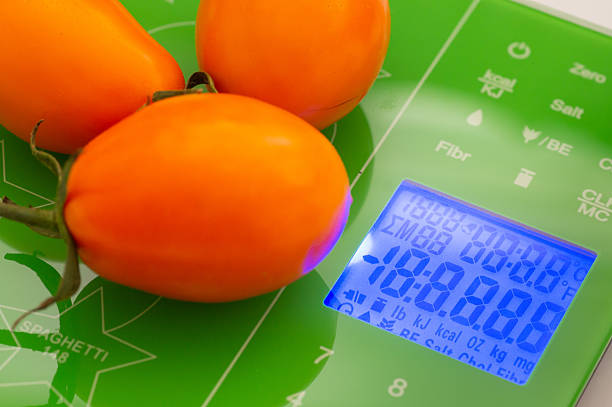 Orange tomatoes on the scales