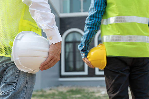 istock inspector engineer and owner project is inspecting construction and quality assurance new house. Engineers or architects or contactor work to build the house before handing it over to the homeowner 2217779886