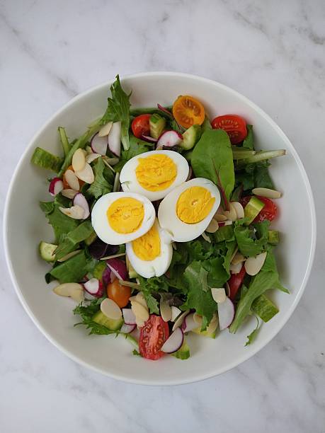 Healthy homemade salad with lettuce, vegetables, and sliced eggs – nutritious and balanced meal