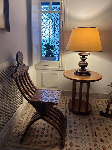 istock Old wooden table and chairs by the window 2217786133