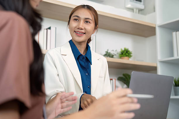 istock Engaging Team Meeting. Professional woman smiling while discussing project details with a colleague. 2217788952