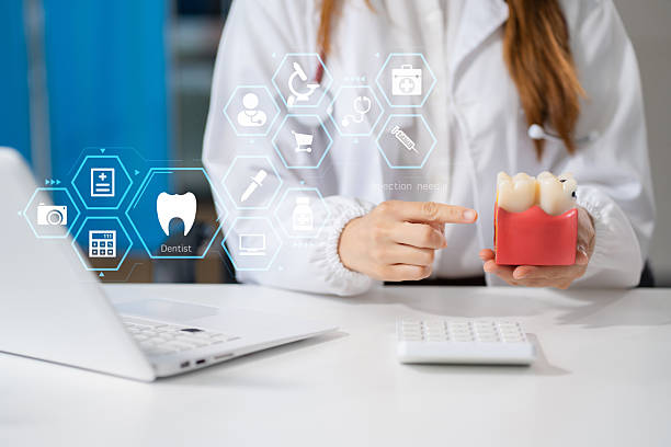 istock dentists writes reports of working with tooth models and analyzing dental treatments. 2217790254