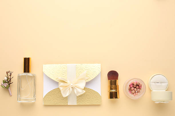 istock Wedding invitations top view. Gift boxes, wedding rings and various wedding trivia on beige table. Background for organising the commemorative date 2217790509