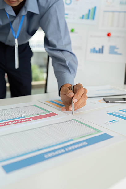 istock Business Professional Reviewing Financial Data. Man writing notes on strategic reports. 2217793392