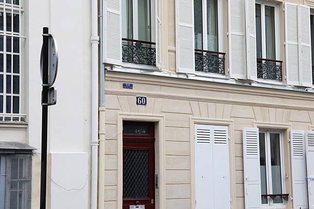 Traditional Parisian Building Facade with Shutters and Number 60