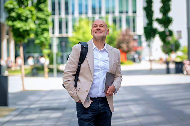 istock Confident businessman walking  through the business district 2217799718