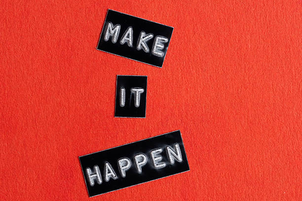 istock Make it happen words on red paper background. Motivational concept 2217802780