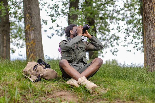 istock Bird watcher enjoying a day of exploration in a forest setting with camera 2217805134