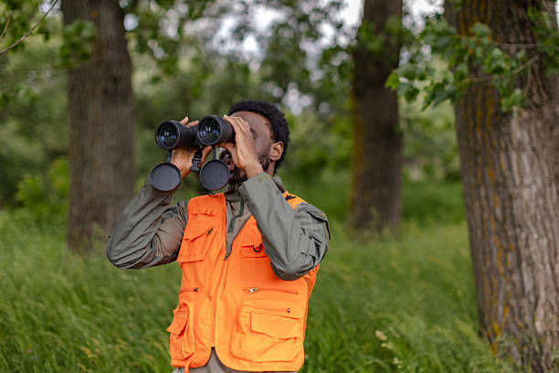 istock Birdwatching in the forest with binoculars as a young man enjoys a weekend adventure 2217806221