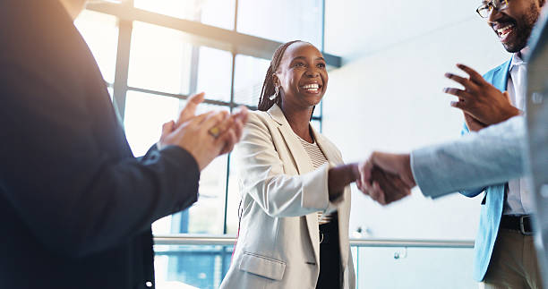 istock Office, handshake and business people with applause for success, congratulations and celebration. Corporate, professional and men and women shaking hands for job promotion, achievement and onboarding 2217806331