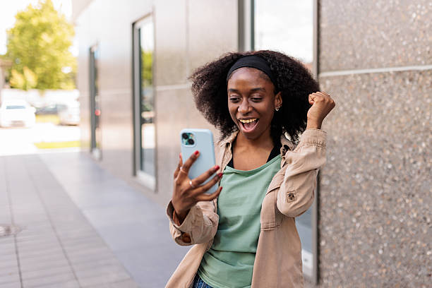 istock Young woman using her smartphone outdoors 2217806437