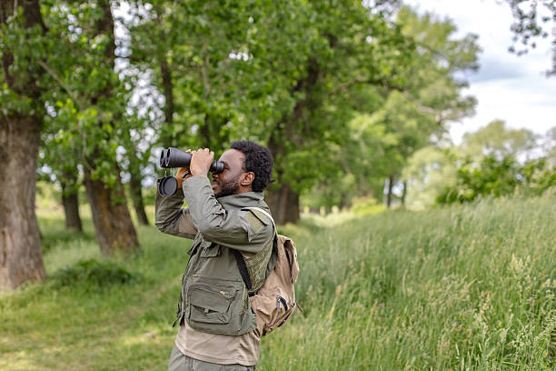 istock Exploring nature through bird watching with binoculars in a lush outdoor forest environment 2217807403