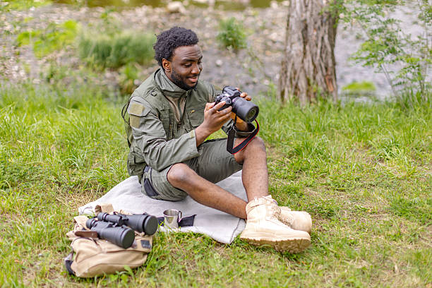 istock Men engaged in bird watching outdoors, enjoying nature and exploration on a sunny weekend 2217807914