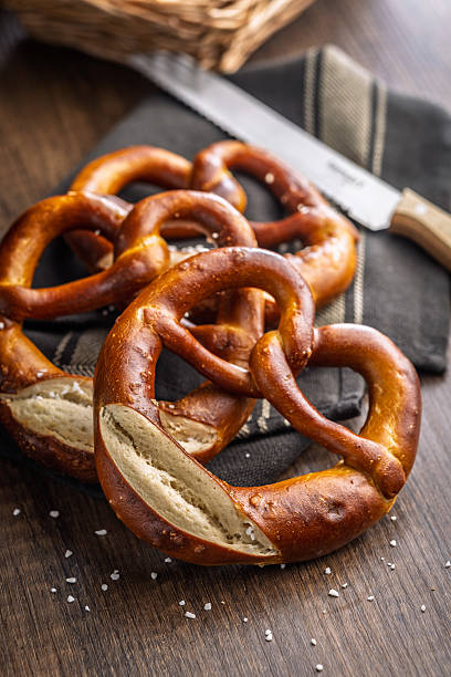 istock Salted bavarian pretzel on wooden table. 2217808337