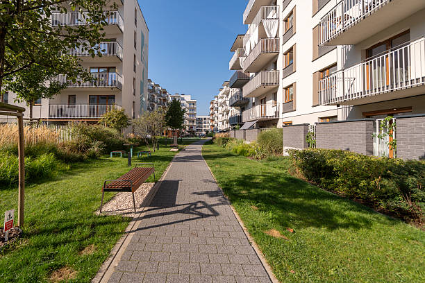 istock Green corridor with a walking path between new apartment buildings 2217808390