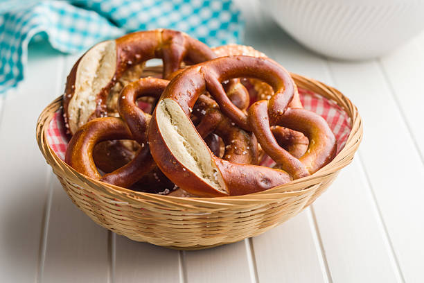 Salted bavarian pretzel in basket on a kitchen table.