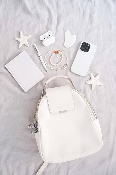 istock Chic and Stylish White Backpack Complete with Accessories Set Against a Soft, Dreamy Background 2217809188