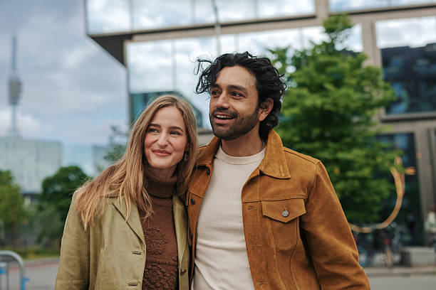 istock Young Couple Walking and Smiling in Urban Setting 2217809247